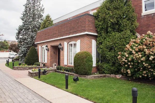 A brick building with a sidewalk in front of it