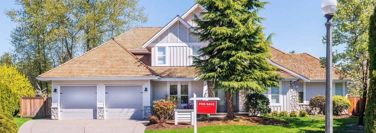 Home with a for sale sign outside
