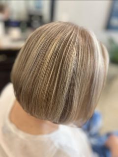 Blonde bob haircut with subtle highlights, viewed from the back.