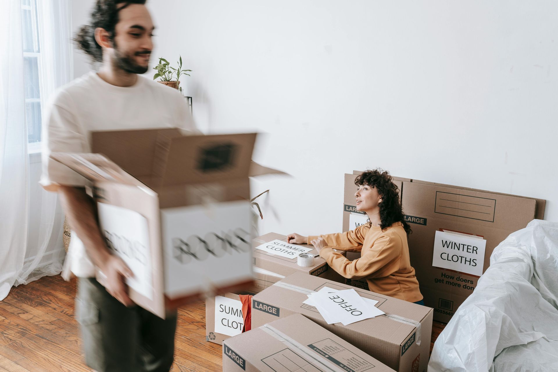 two people unpacking moving boxes