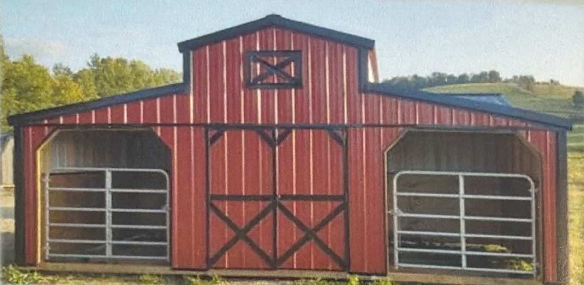 Red wooden barn with black trim and three garage-style doors on a grassy hillside