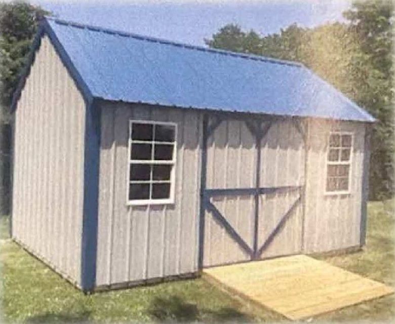 Blue-roofed gray garden shed with white trim, double doors, and a small wooden ramp