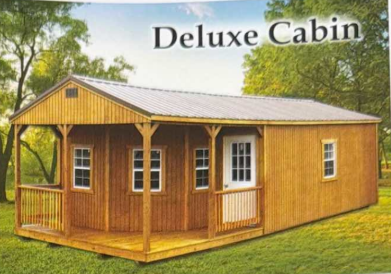 Wooden deluxe cabin with porch and white-trim windows in a grassy yard
