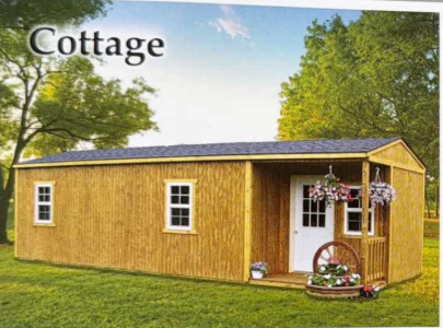 Small wooden cottage with white trim, porch flowers, and green trees in a grassy yard