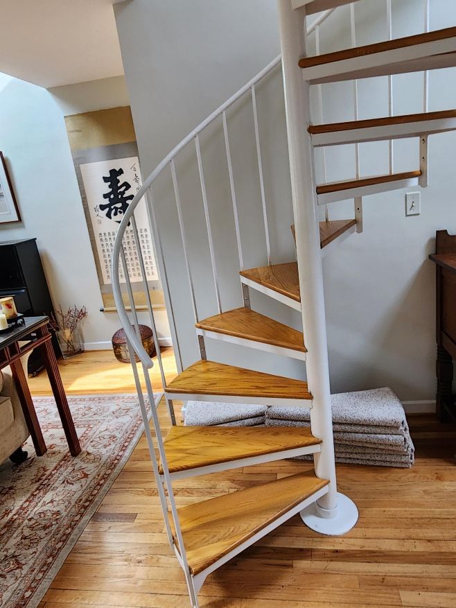 custom oak treads made and finished by us to replace carpeting and plywood on a spiral stair case