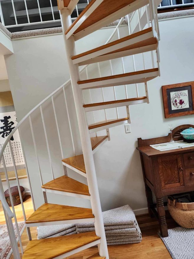 custom oak treads made and finished by us to replace carpeting and plywood on a spiral stair case
