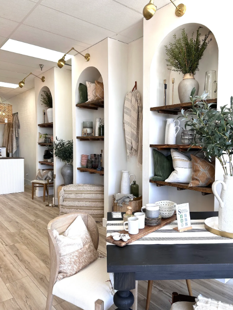A room with a table and chairs and shelves