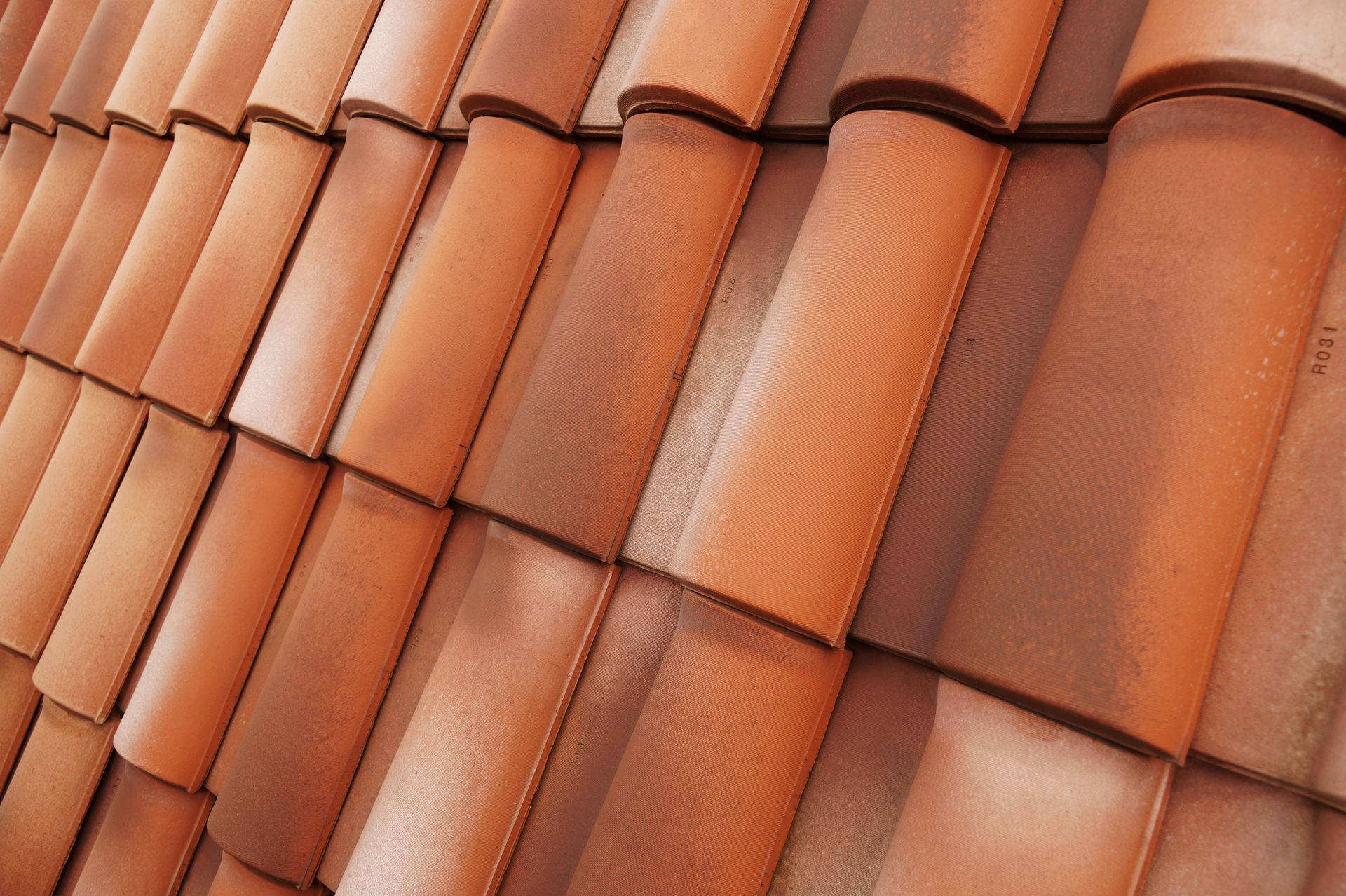 Close-up of orange terracotta roof tiles in a diagonal pattern
