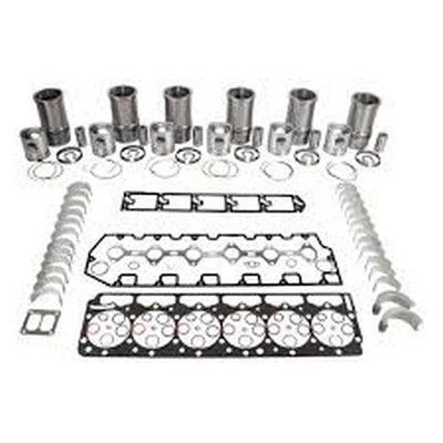 Componentes del kit de reconstrucción del motor dispuestos sobre una superficie blanca, incluidos pistones, juntas y cojinetes.