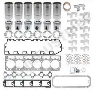 Componentes del kit de reconstrucción del motor dispuestos: cilindros, pistones, juntas y piezas pequeñas.