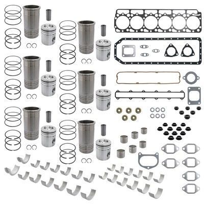 Kit de reconstrucción de motor: cilindros, pistones, anillos, juntas, cojinetes y sellos dispuestos sobre una superficie blanca.