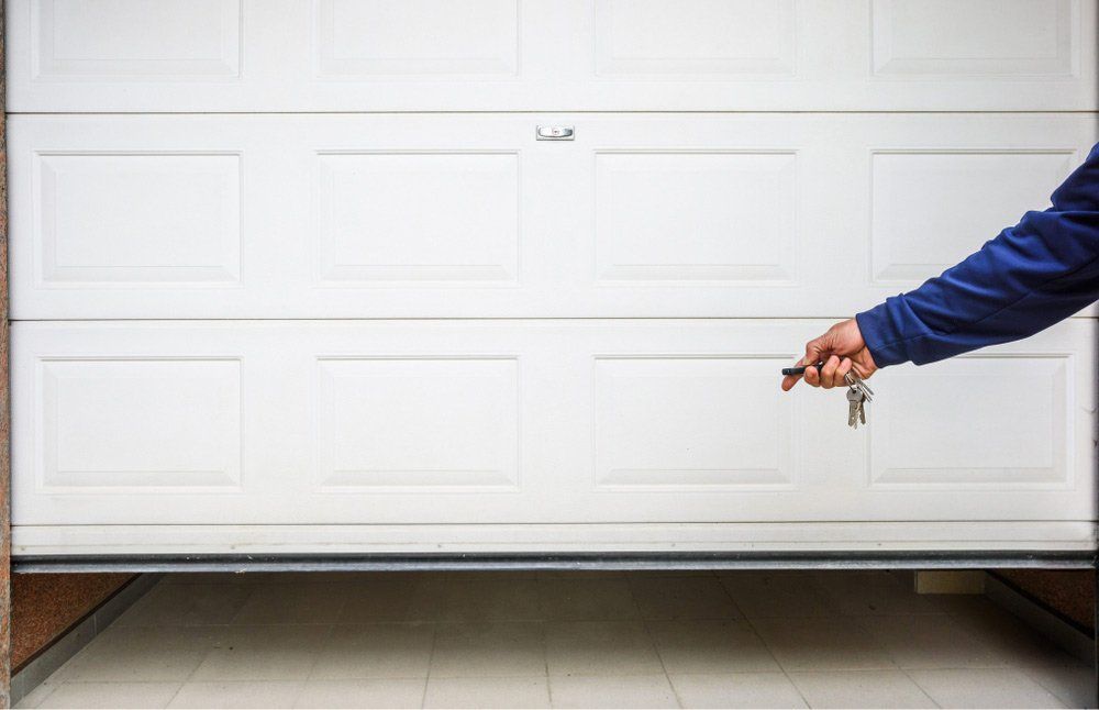 Hand Opening Garage Door using the Remote — Garage Doors Townsville, QLD