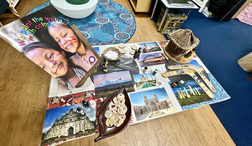 A collage of pictures on a wooden floor with a book on top of it.