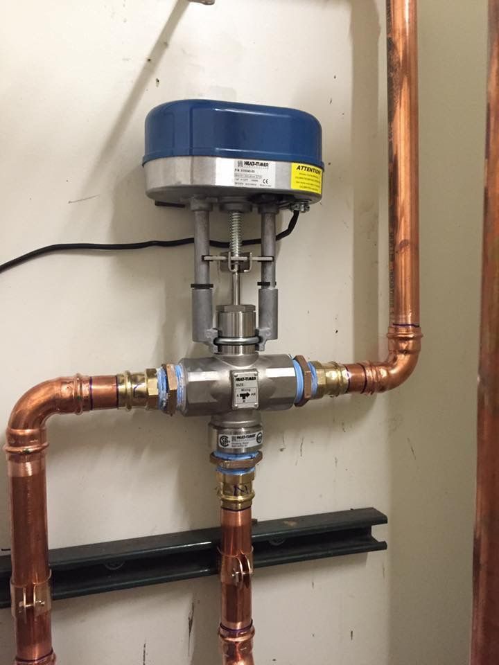 A copper pipe with a valve attached to it