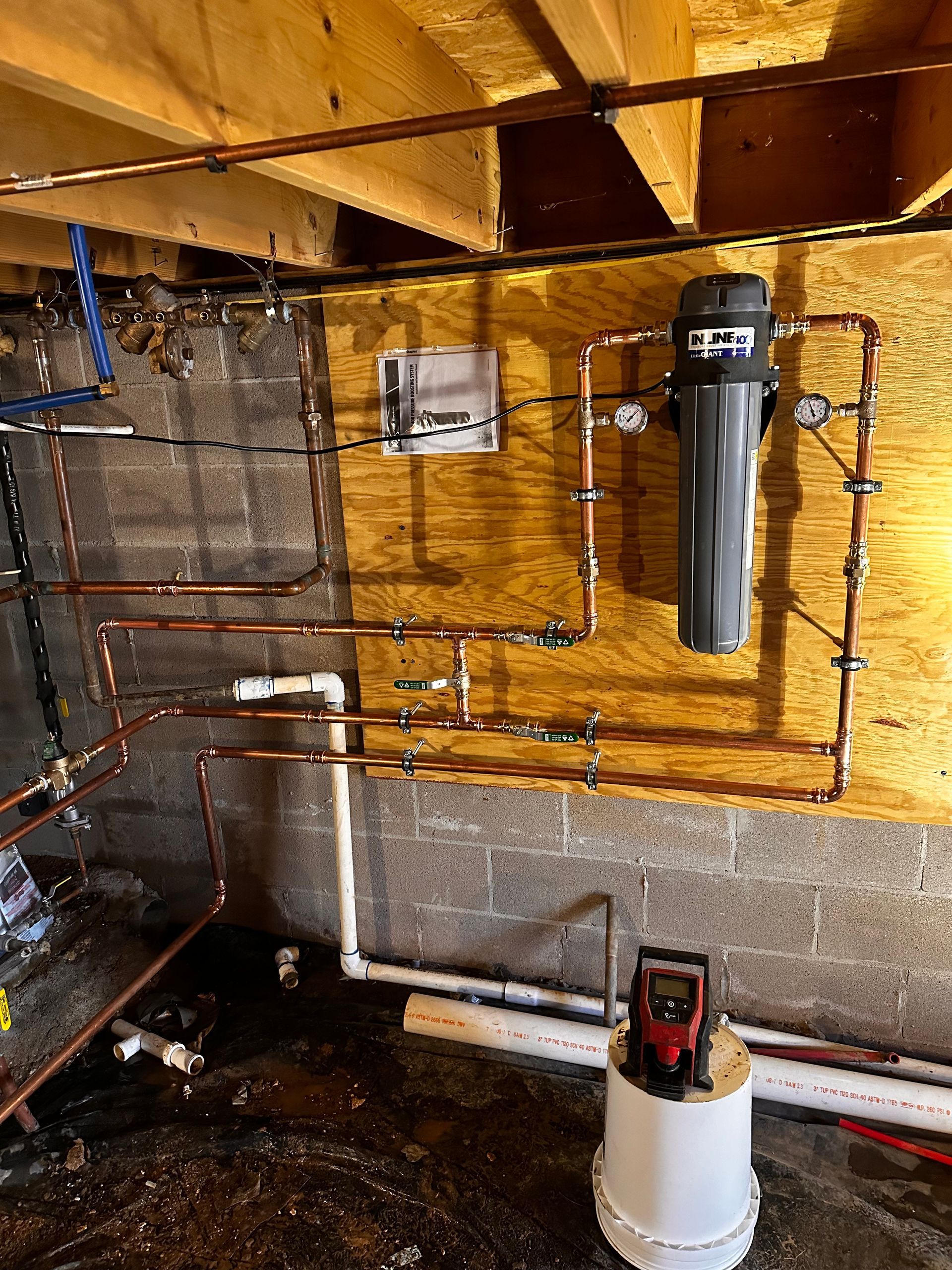 A plumbing system is being installed in a basement
