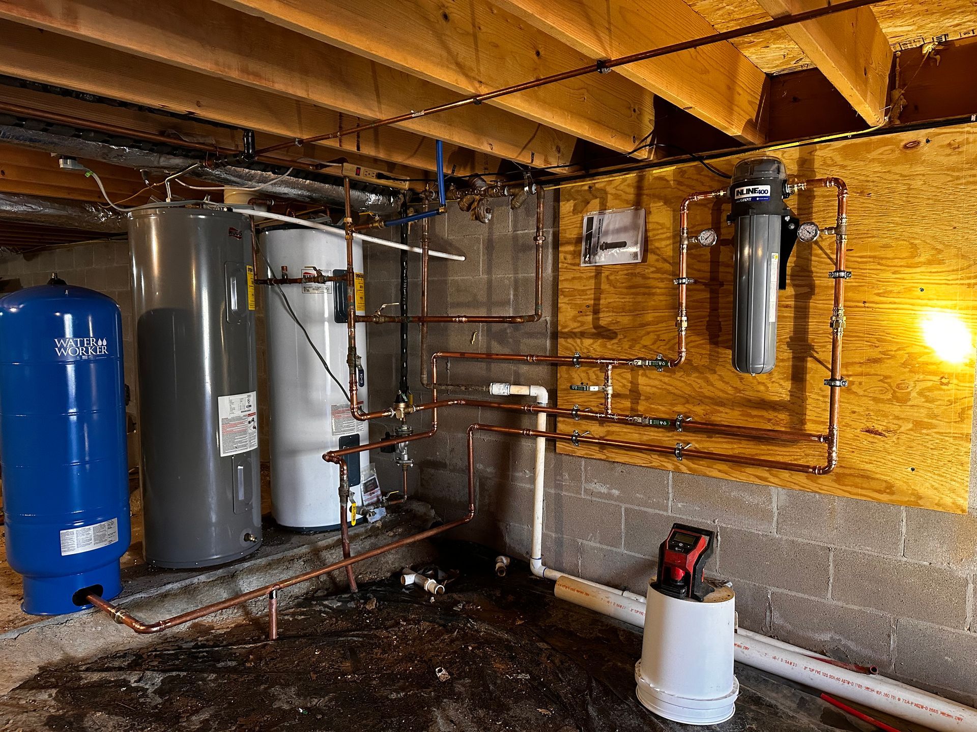 A room with a lot of pipes and water heaters