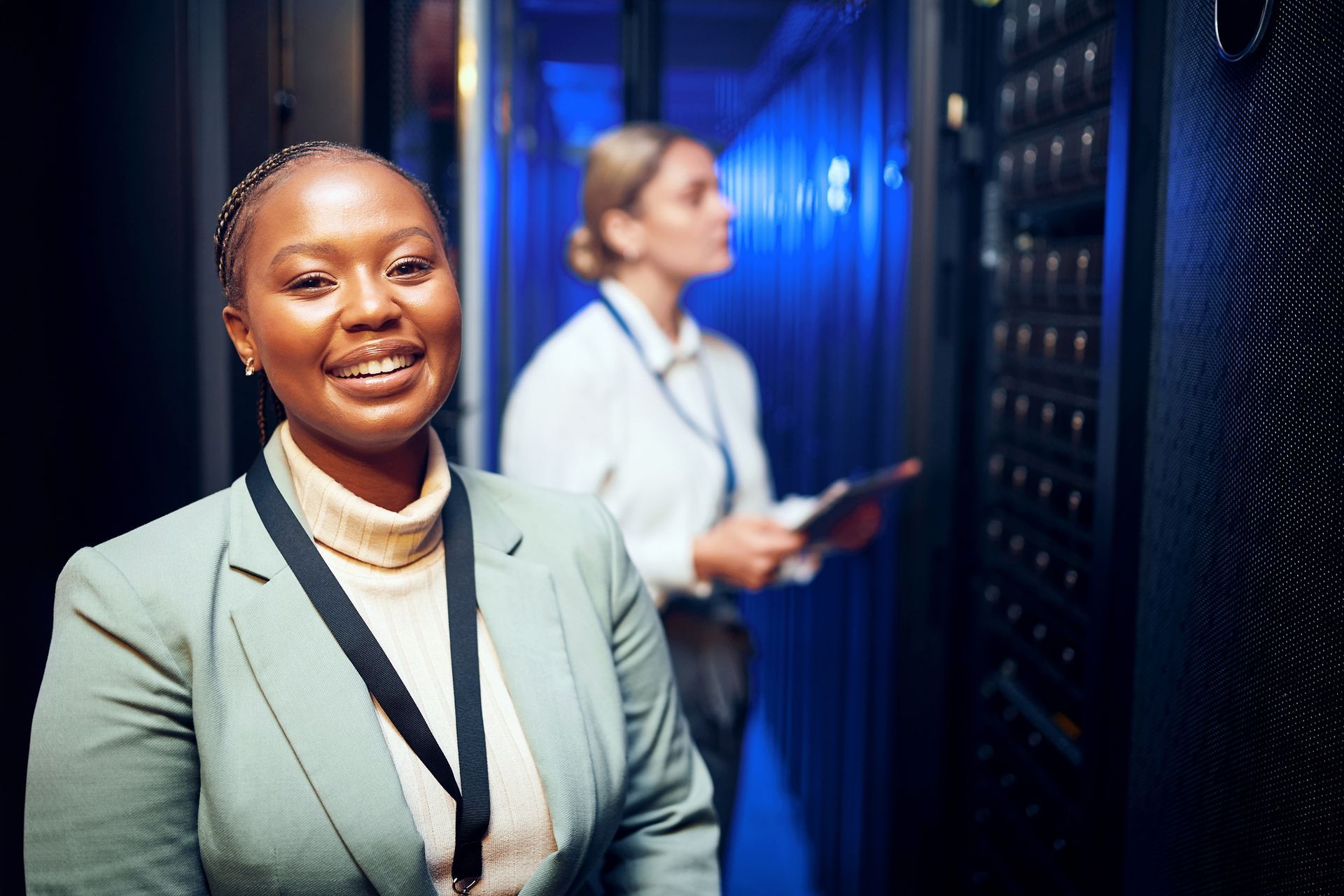Peoplebank employee in a light green blazer stands in a server room