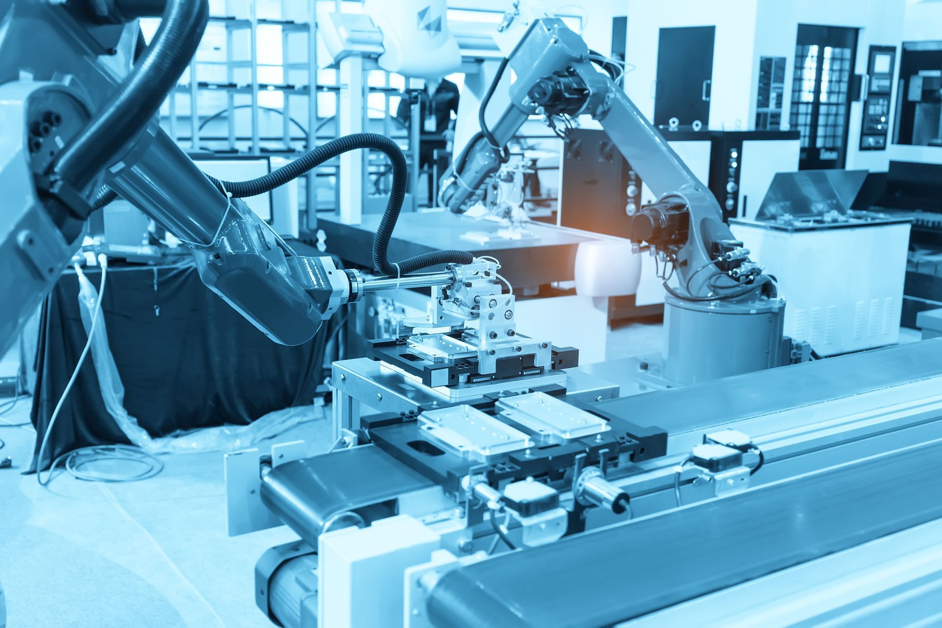 A robotic arm is moving a conveyor belt in a factory.
