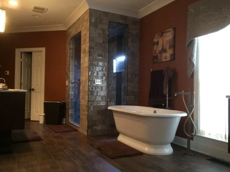 Spa-like bathroom with a freestanding tub, tiled shower, and bright window light