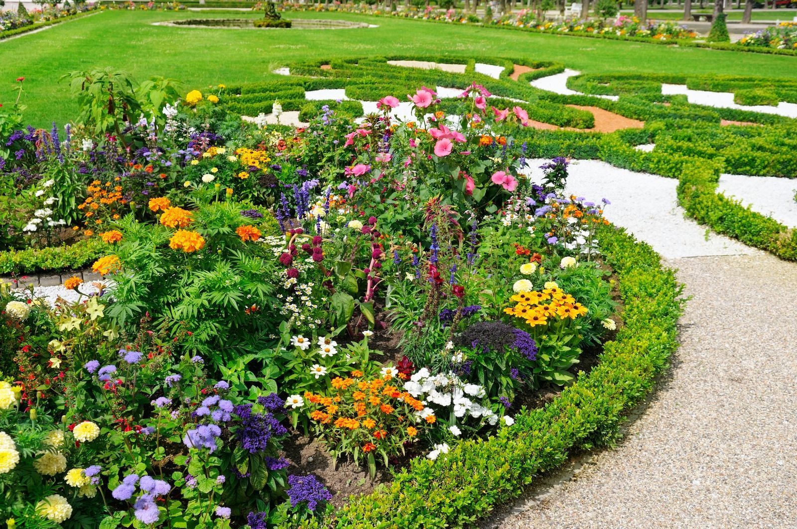 Flowerbed and gravel path in a formal garden.