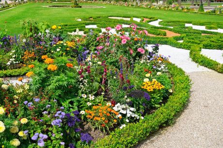 Flowerbed and gravel path in a formal garden.