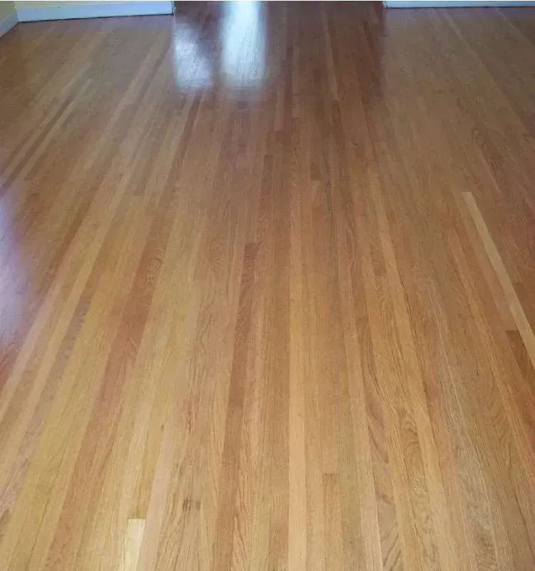 A close up of a wooden floor in a living room.