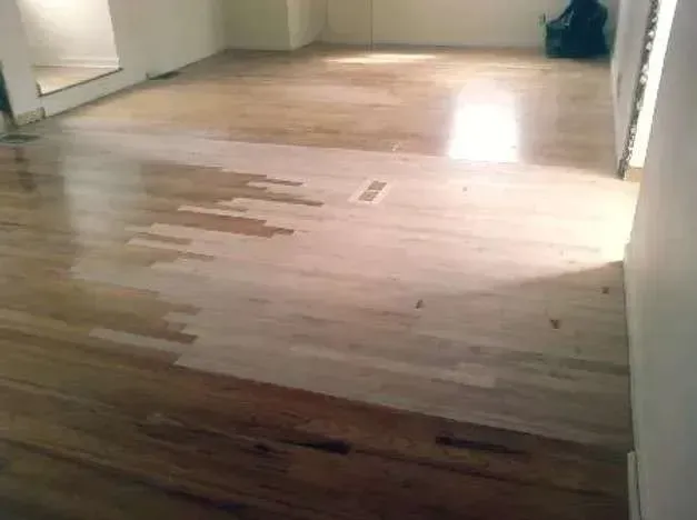 A room with a wooden floor and white walls.