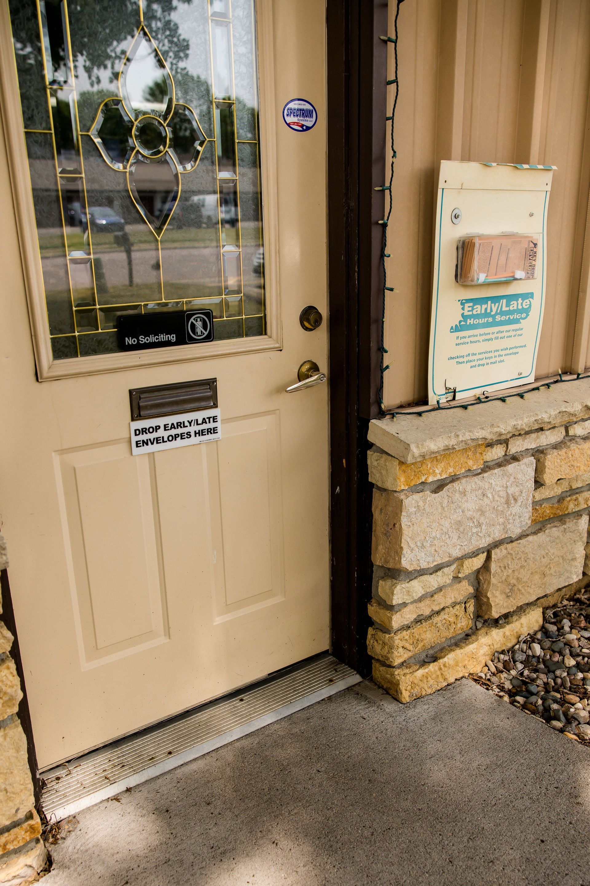 Beige door with glass panels and a sign that reads 