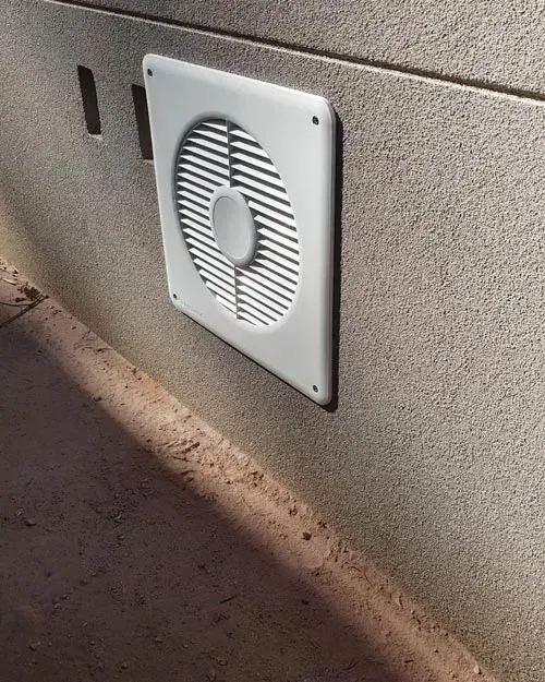 A White Fan Is Mounted to the Side of a Building | East Gosford, NSW | Clark’s Insulations 