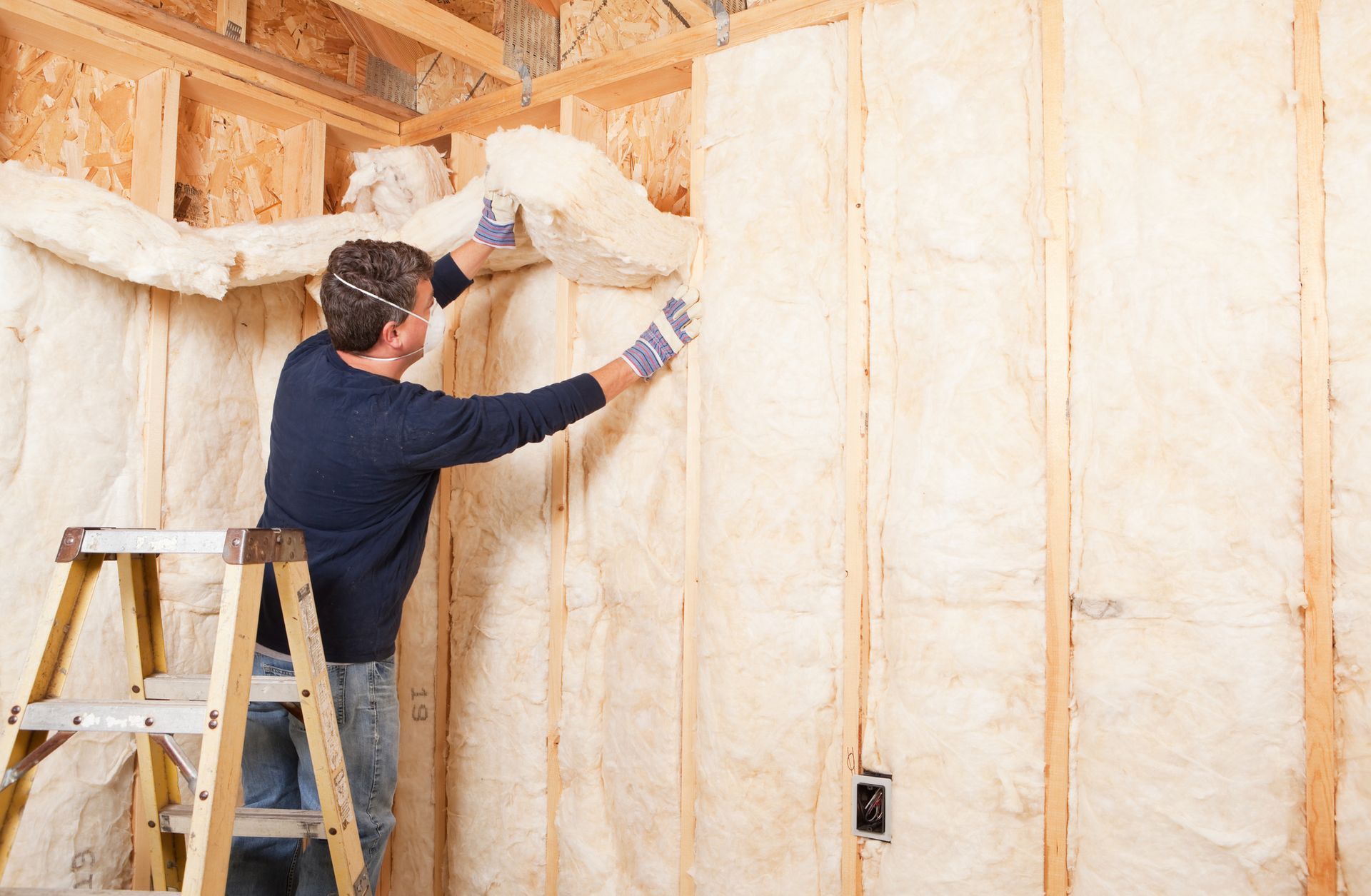 A Man on a Ladder Is Insulating a Wall | East Gosford, NSW | Clark’s Insulations 