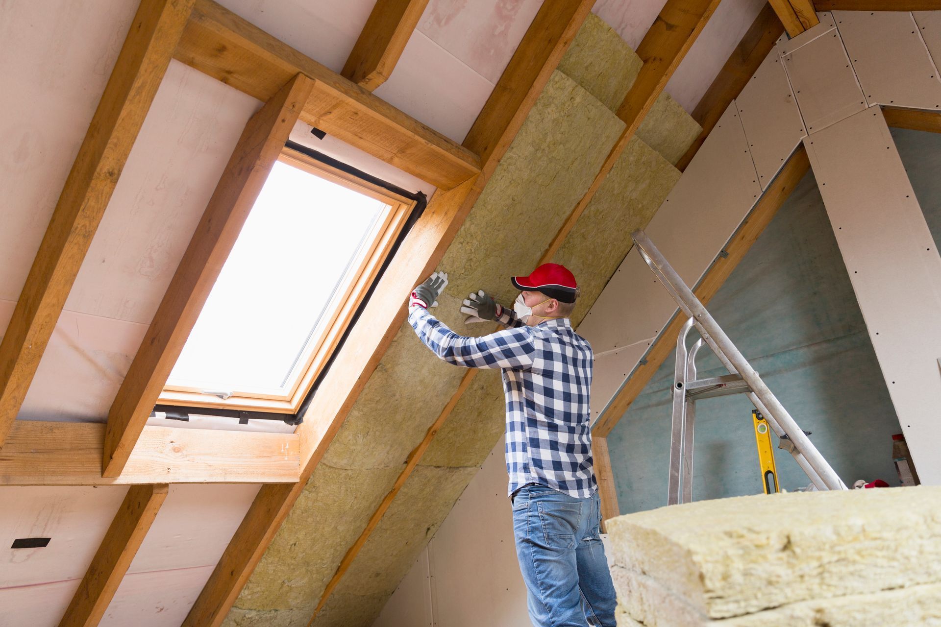 A Man in a Plaid Shirt Is Insulating a Roof | East Gosford, NSW | Clark’s Insulations