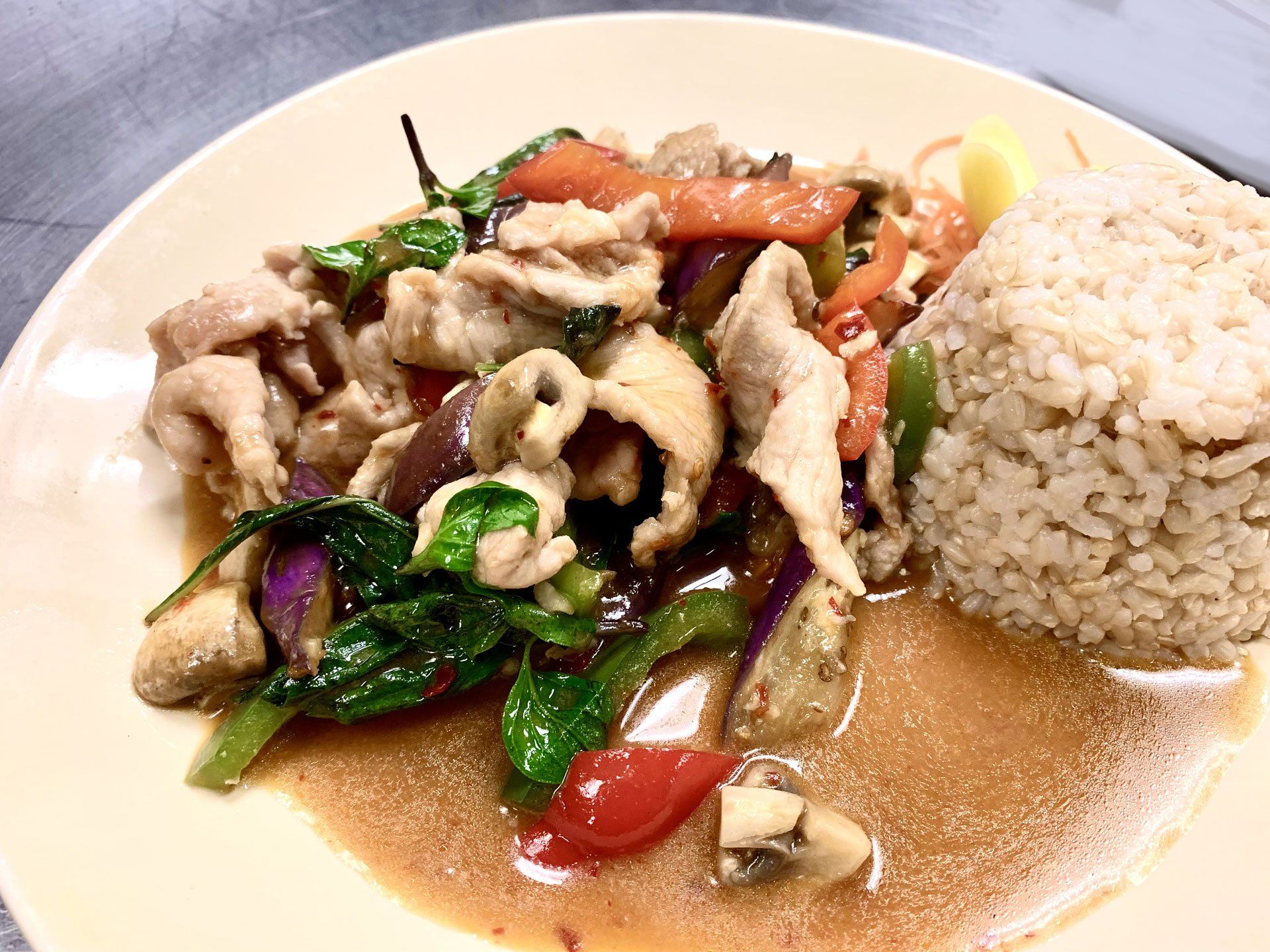 A plate of food with rice and vegetables on a table.