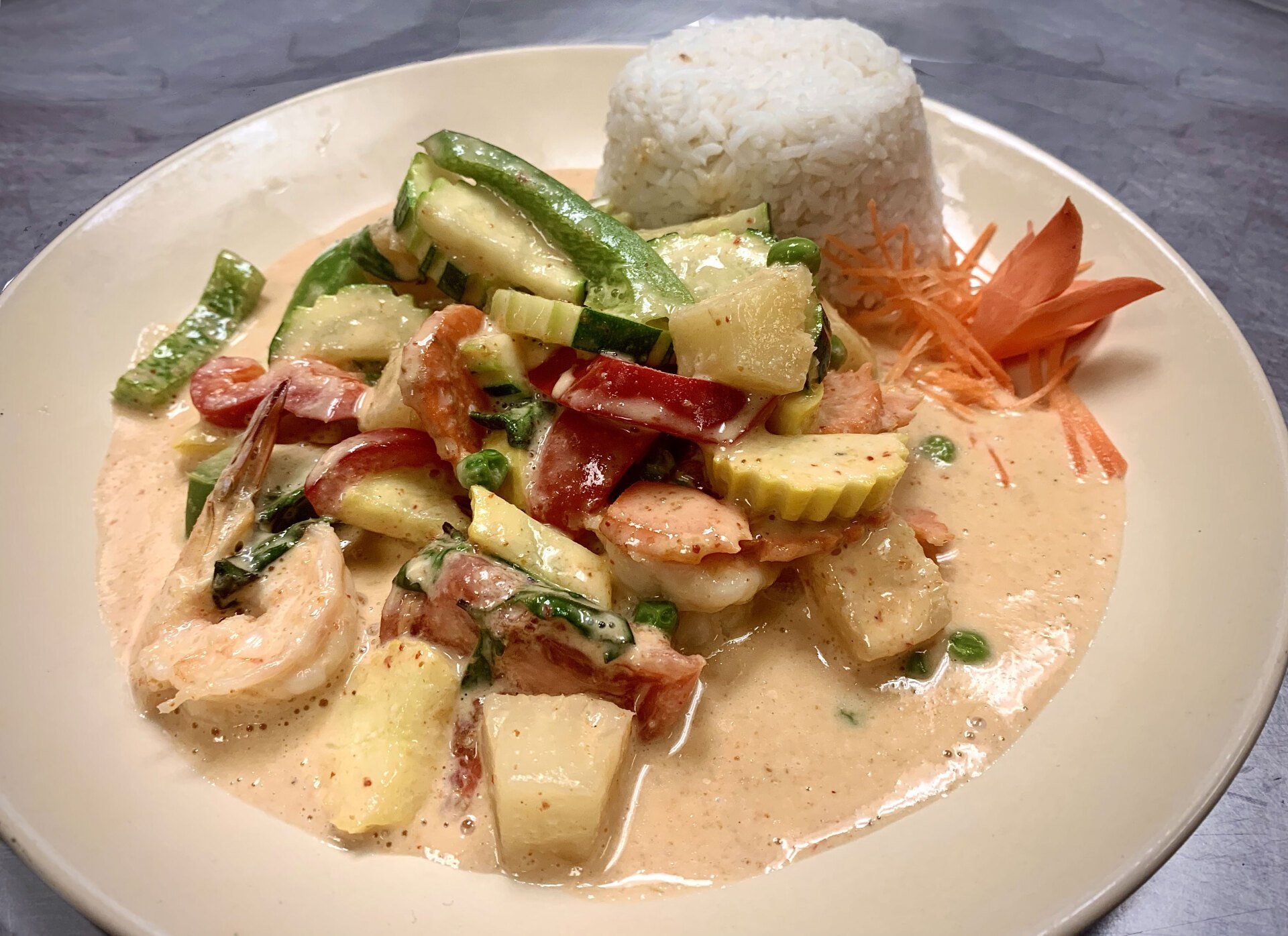 A plate of food with rice and vegetables on a table.