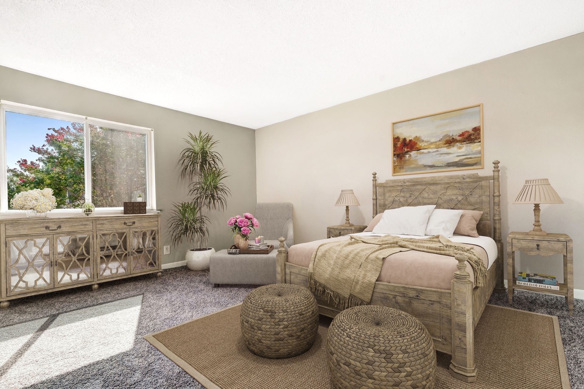 A bright, neutrally toned bedroom with a wooden bed, a console table, an armchair, and two round ottomans on a rug.