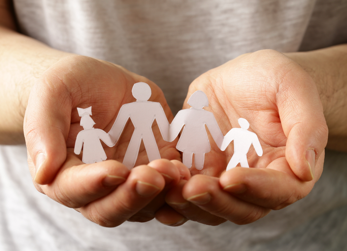 A paper chain of a family holding hands.