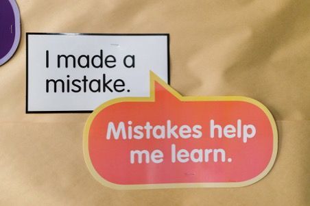 a note stapled to a board that reads 