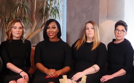 Four ladies of the firm sitting on a couch