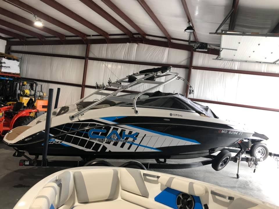 A boat is sitting in a warehouse next to another boat.