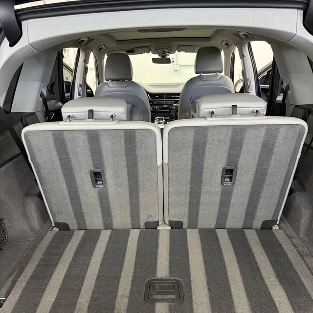 A close up of a white leather seat in a car.
