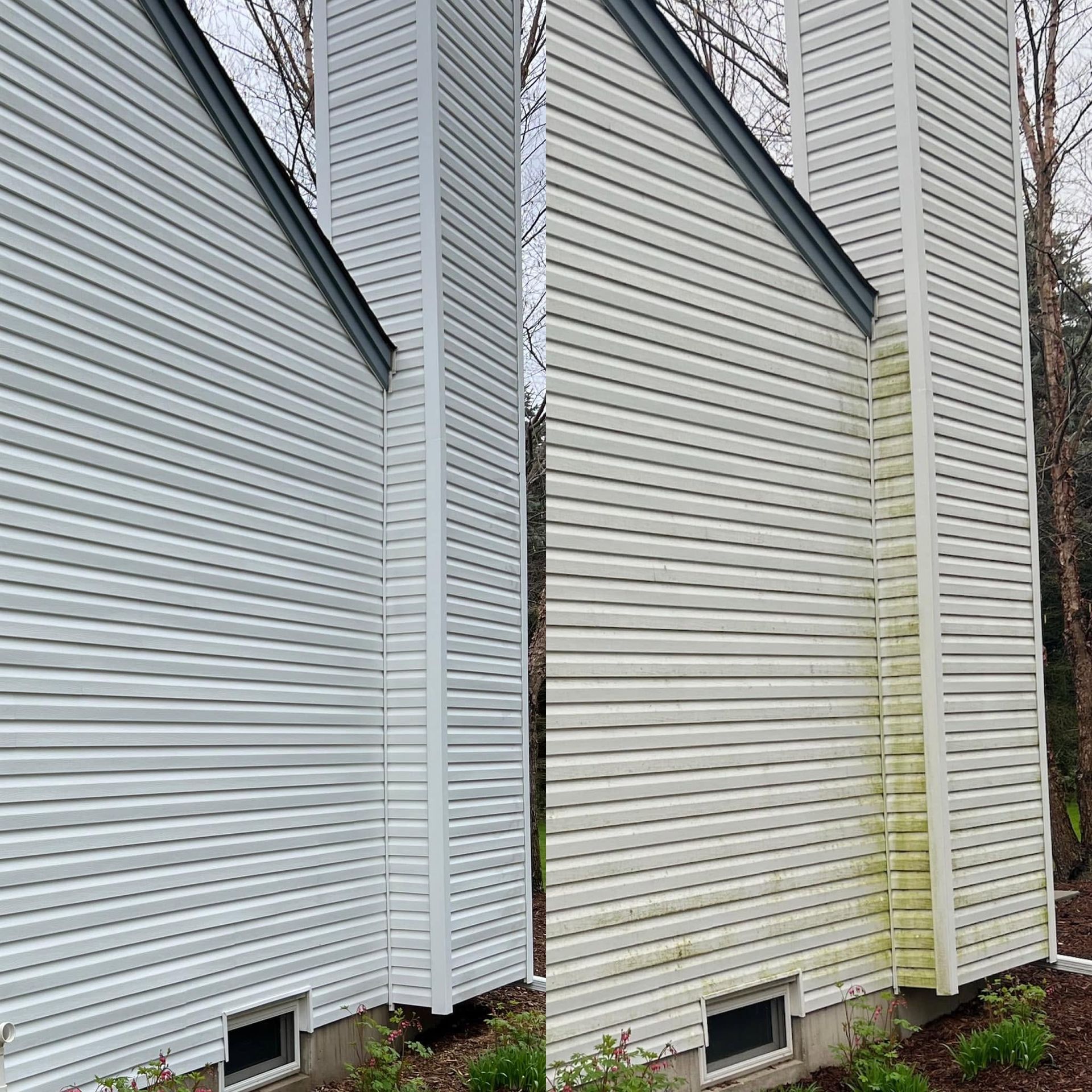 White house siding with two basement vents and yellow-green staining near the corner trim