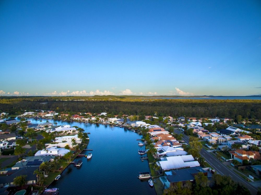 Aerial View Of Houses Along A Canal With Boats Docked — Superstretch300 Limousines in Noosa, QLD