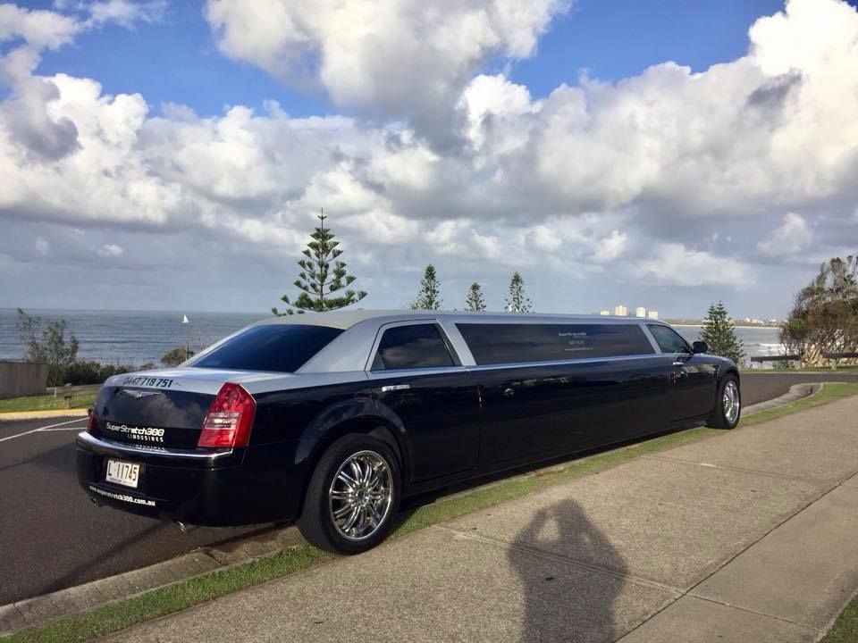 A Black Limousine is Parked on the Side of the Road — Superstretch300 Limousines in Sunshine Coast, QLD