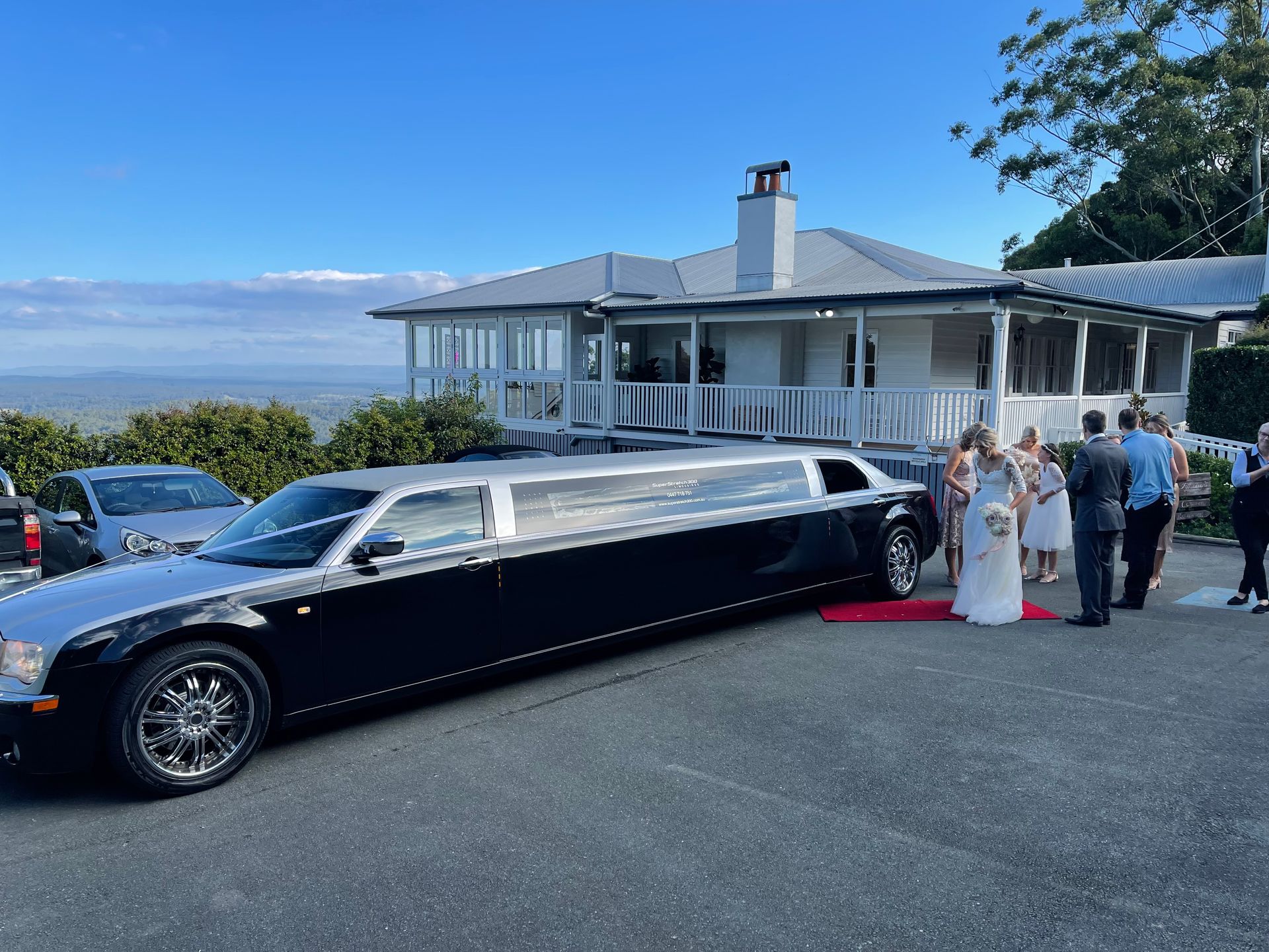 Black And Silver Limousine Parked On A Driveway — Superstretch300 Limousines In Coolum, QLD