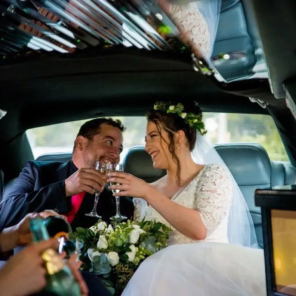 Bride And Groom Toast With Champagne In A Limousine — Superstretch300 Limousines In Mooloolaba, QLD