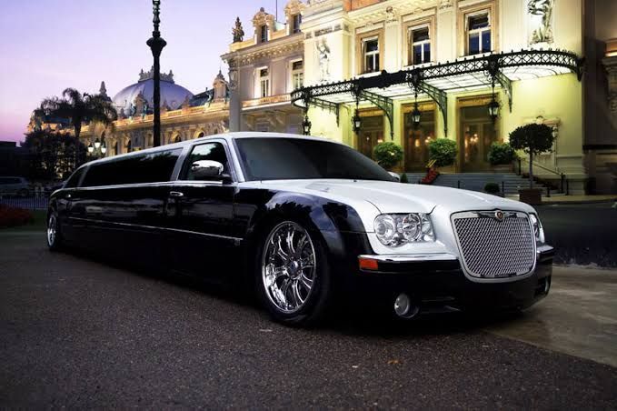 A Black and White Limousine is Parked in Front of a Building — Superstretch300 Limousines in Sunshine Coast, QLD