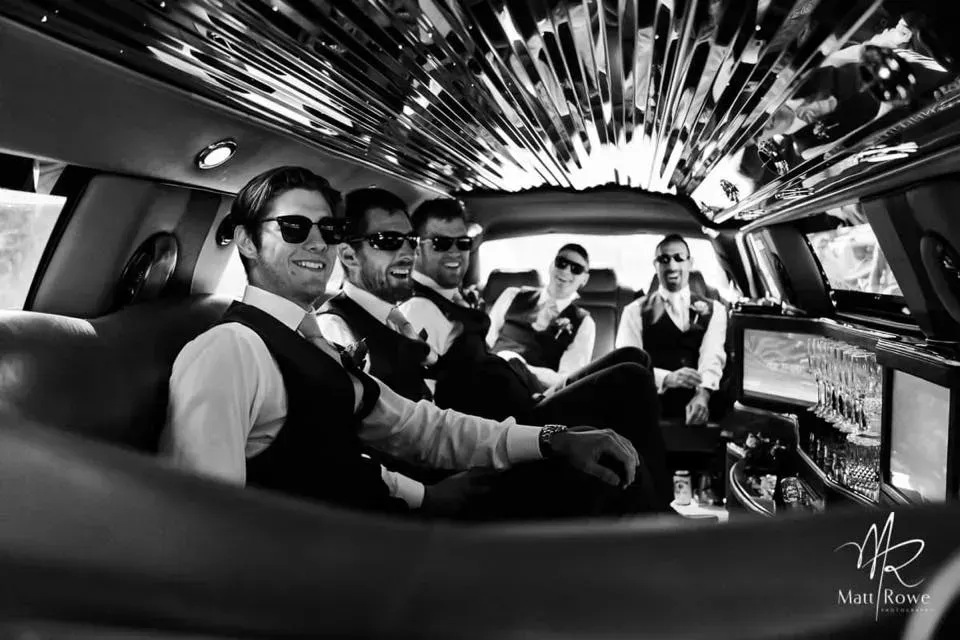 A Group of Men Are Sitting in a Limousine — Superstretch300 Limousines in Sunshine Coast, QLD