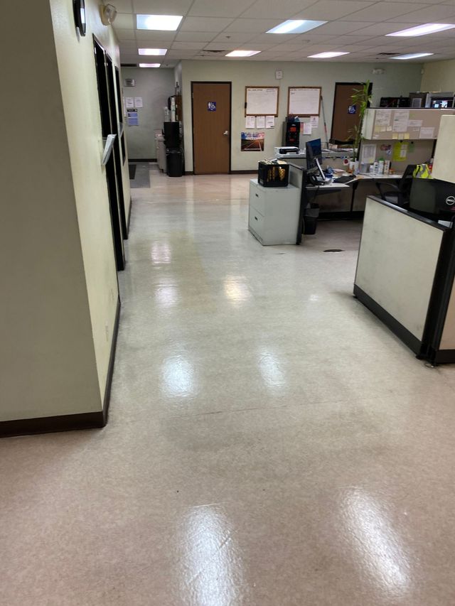A hallway with a desk in the middle of it