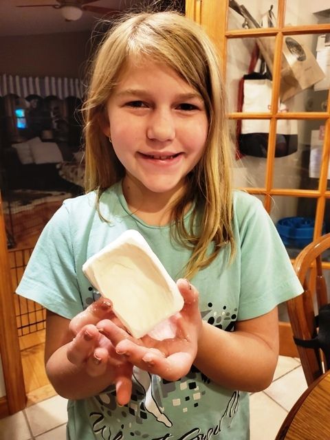 student holding artwork