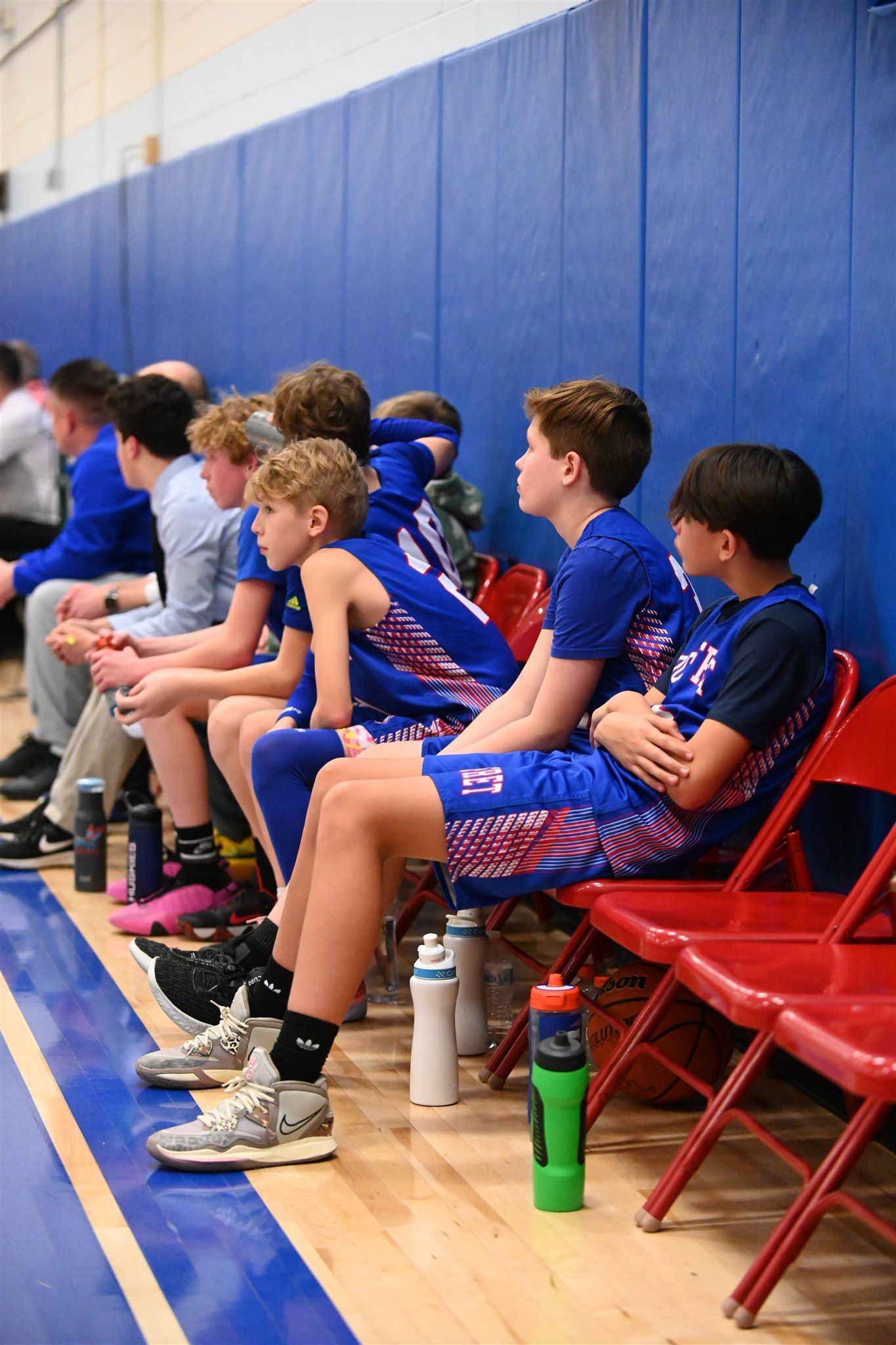 members of the 2023-24 boys basketball team on the sidelines