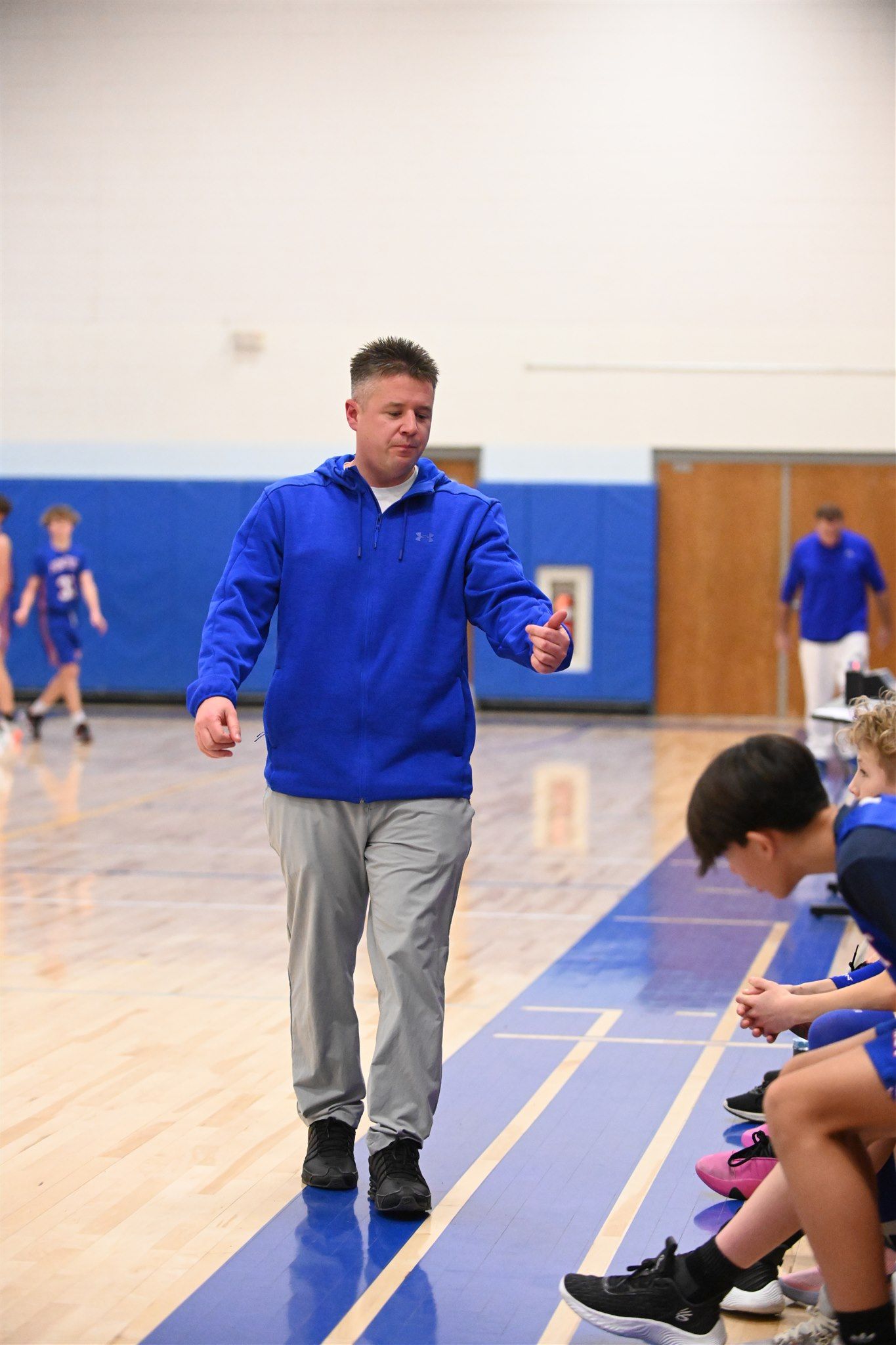 coach of the 2023-24 boys basketball team on the court
